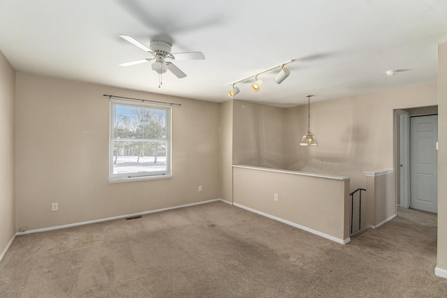 spare room featuring light carpet and ceiling fan