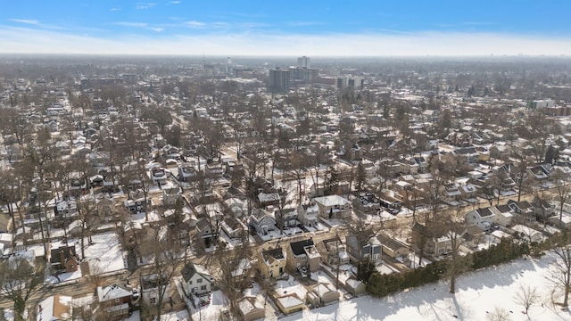 snowy aerial view with a city view