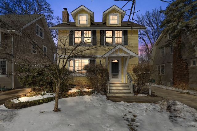 traditional style home featuring a chimney