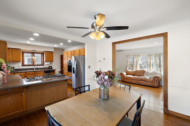 dining room featuring a wealth of natural light, dark wood-style flooring, and recessed lighting