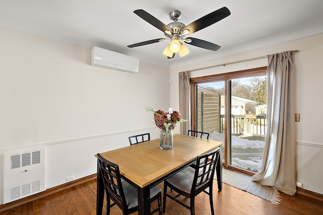 dining room with dark wood finished floors, radiator, a ceiling fan, an AC wall unit, and baseboards