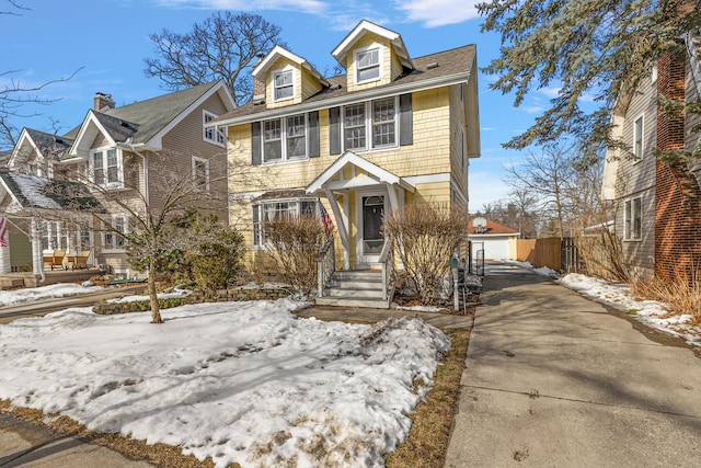 american foursquare style home with fence