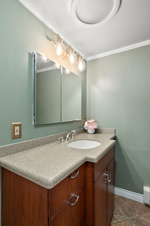 bathroom featuring ornamental molding, tile patterned floors, vanity, and baseboards