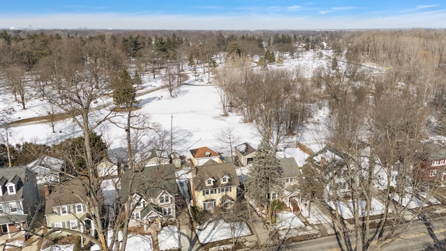 snowy aerial view with a residential view