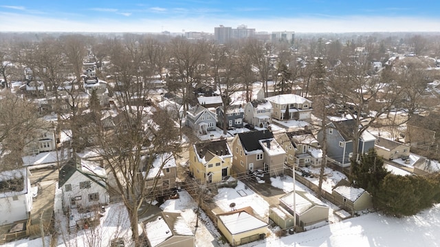 snowy aerial view with a residential view