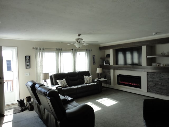 living area with ceiling fan, light colored carpet, and a glass covered fireplace