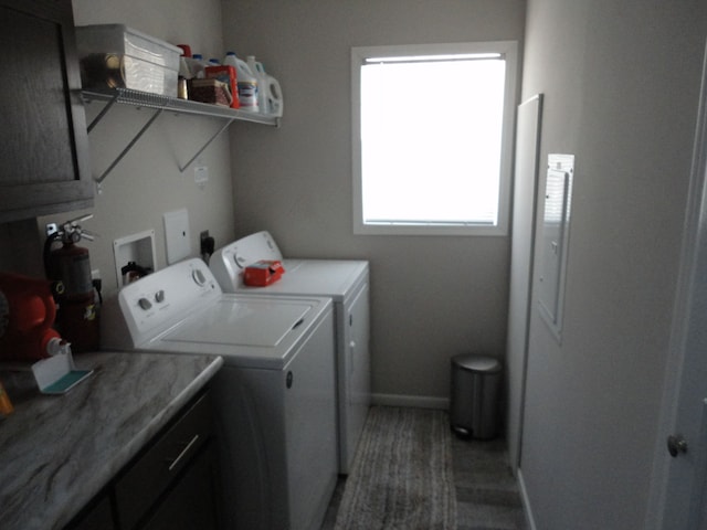 laundry room with independent washer and dryer and cabinets