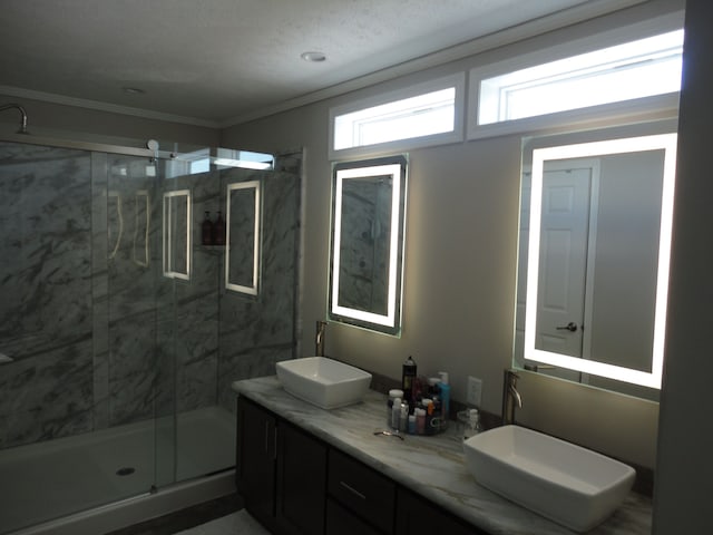 bathroom with ornamental molding, vanity, and an enclosed shower