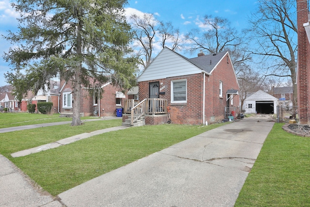 bungalow-style house with an outbuilding, brick siding, a front lawn, and a detached garage