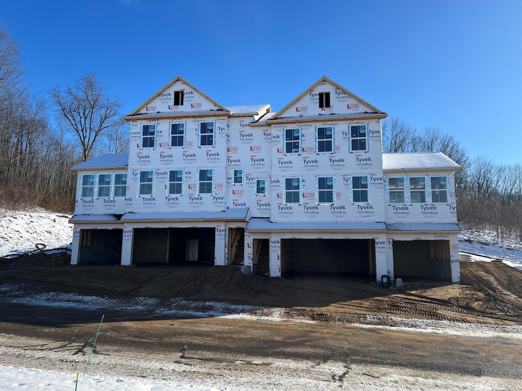 unfinished property featuring a garage