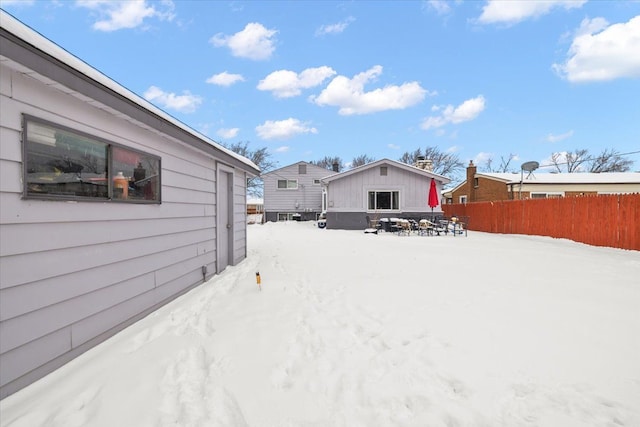 snowy yard with fence