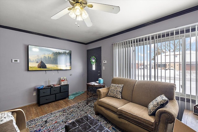 living area with ornamental molding, a water view, baseboards, and wood finished floors