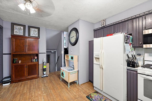 kitchen featuring a textured ceiling, ceiling fan, white appliances, light countertops, and light wood-type flooring