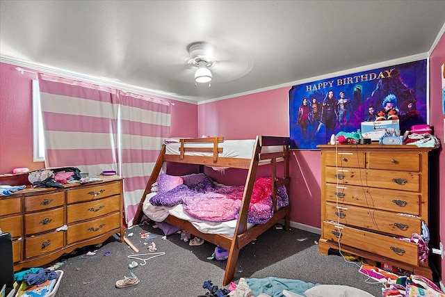 bedroom featuring ceiling fan, dark carpet, and crown molding