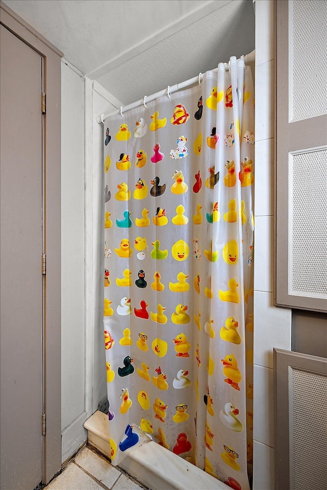 bathroom with a shower with shower curtain