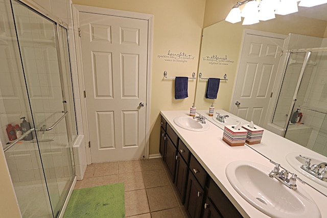 bathroom with tile patterned flooring, vanity, and walk in shower