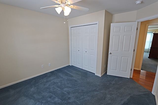 unfurnished bedroom with a closet, ceiling fan, and dark colored carpet