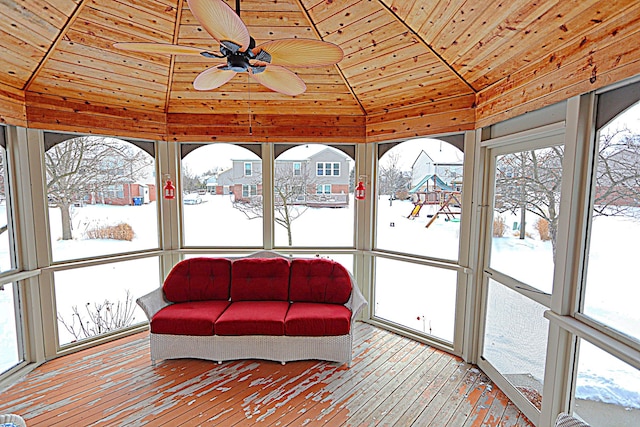 sunroom featuring ceiling fan, lofted ceiling, wooden ceiling, and plenty of natural light