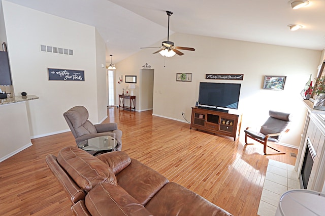 living room with light hardwood / wood-style flooring, ceiling fan, and lofted ceiling