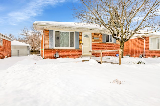 view of front of house featuring brick siding and a detached garage