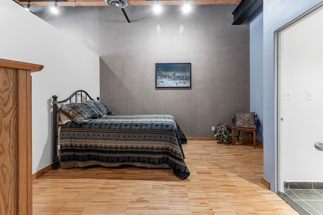 bedroom featuring ceiling fan, baseboards, and track lighting