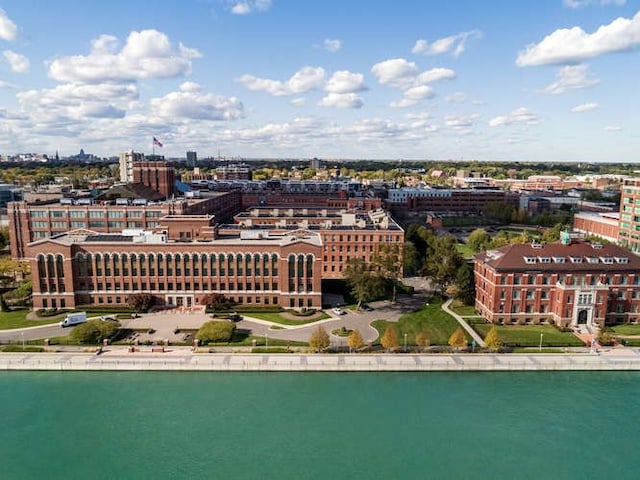 drone / aerial view featuring a water view and a city view