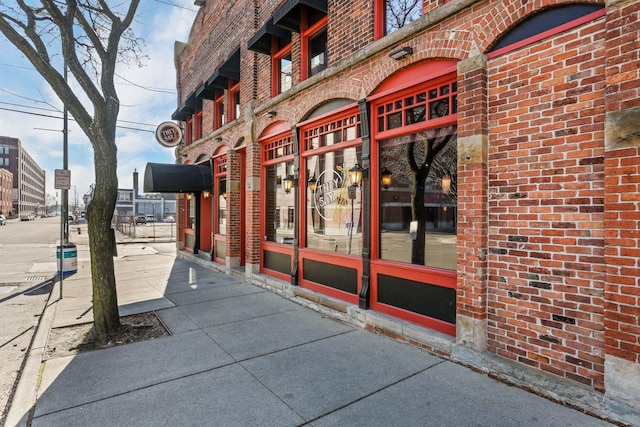 property entrance featuring brick siding