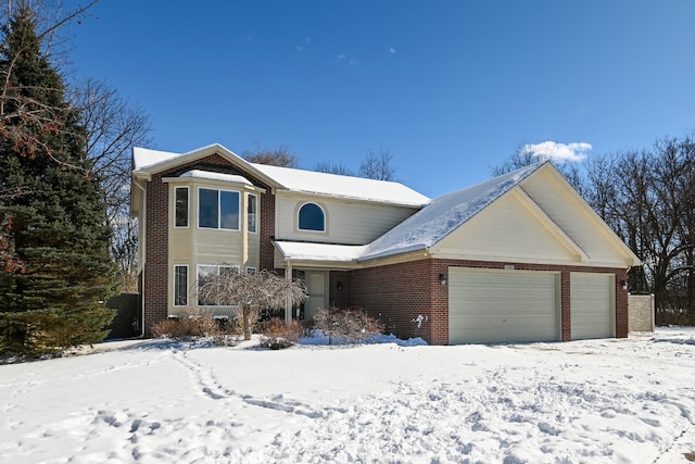 traditional-style home featuring an attached garage and brick siding