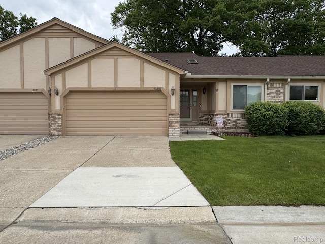 42201 Hidden Brook Dr Unit 68, Clinton Township, MI 48038 - view of front of home with a garage, stucco siding, concrete driveway, a front lawn, and a shingled roof