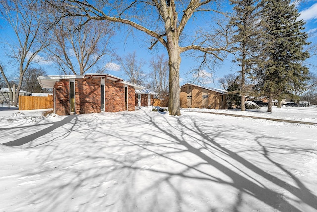 yard layered in snow with fence