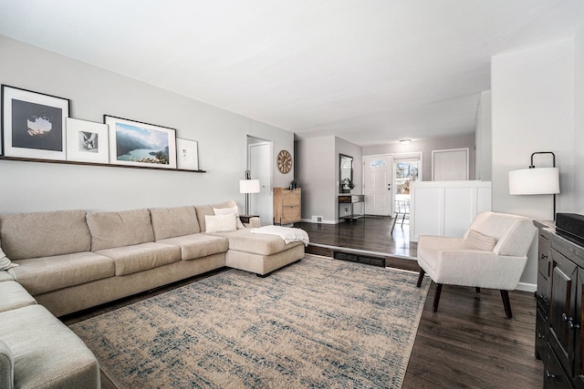 living room featuring dark wood finished floors and baseboards