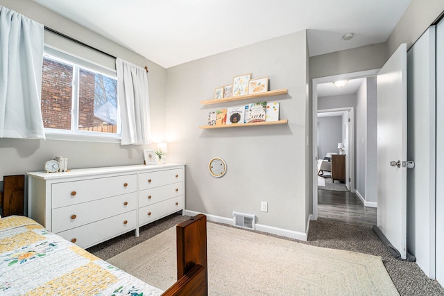 bedroom with visible vents, dark carpet, and baseboards