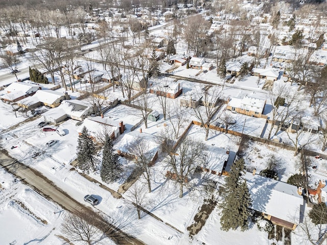 snowy aerial view with a residential view