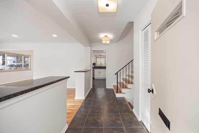 corridor with plenty of natural light and sink