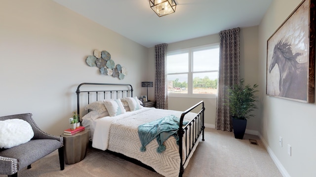 bedroom featuring light colored carpet