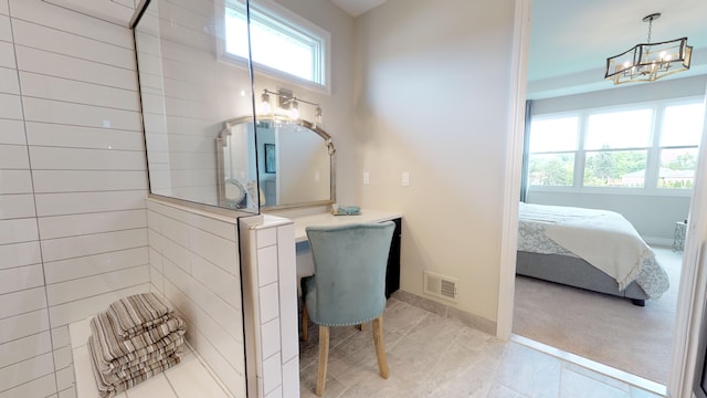 bathroom with a chandelier