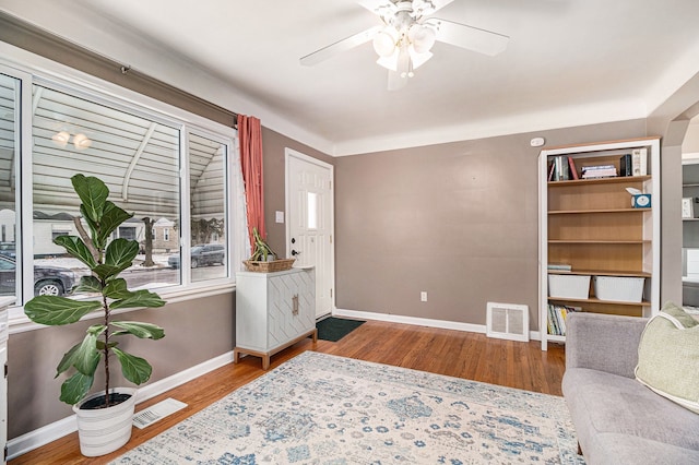 sitting room featuring ceiling fan and hardwood / wood-style floors