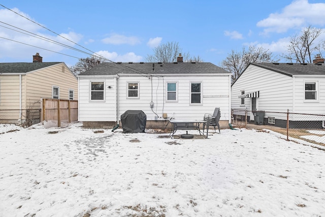 view of snow covered rear of property