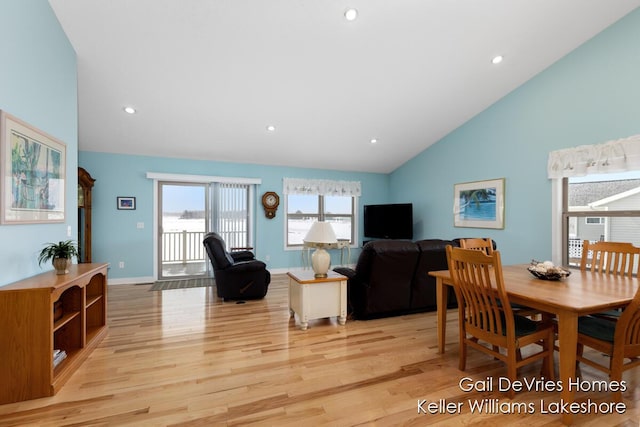 dining area featuring high vaulted ceiling, recessed lighting, light wood-style flooring, and baseboards