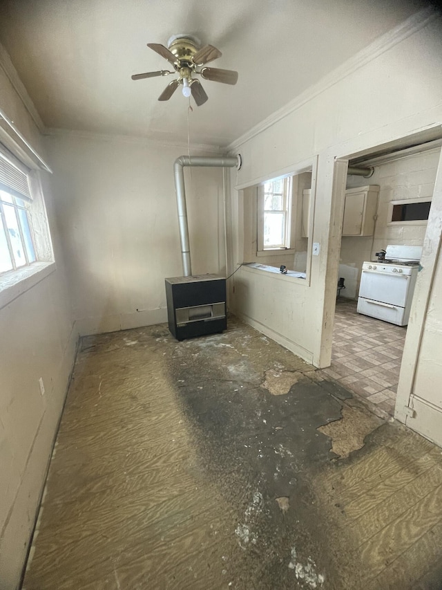 interior space featuring ceiling fan and crown molding