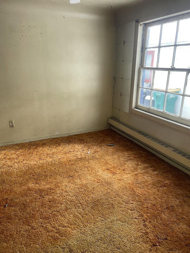 spare room featuring a baseboard heating unit