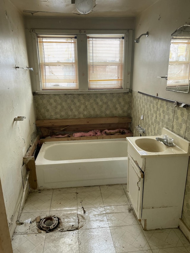 bathroom with vanity and a washtub