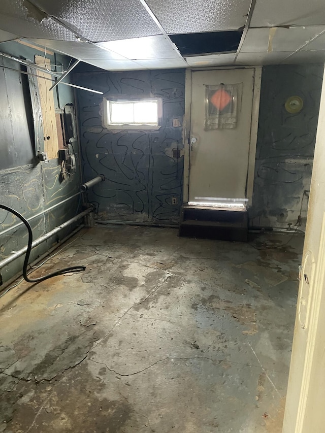 basement featuring a paneled ceiling