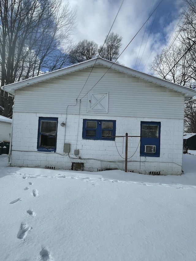 view of snow covered rear of property