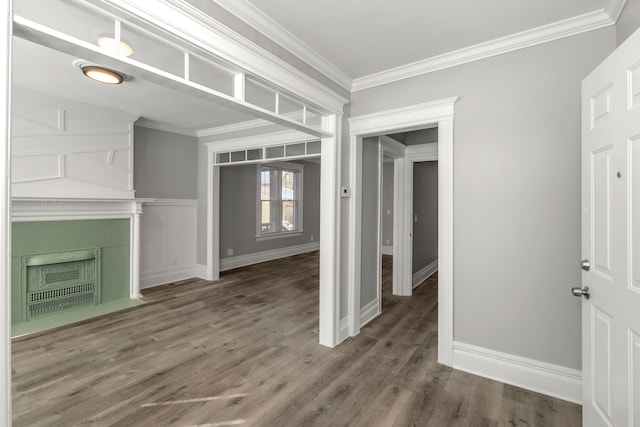 unfurnished living room with crown molding and dark wood-type flooring