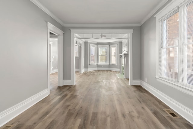 interior space with ornamental molding and wood-type flooring