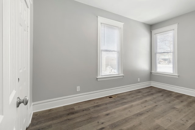 unfurnished room with dark hardwood / wood-style floors