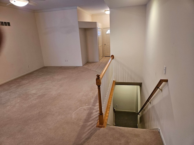 interior space with carpet floors, visible vents, and crown molding