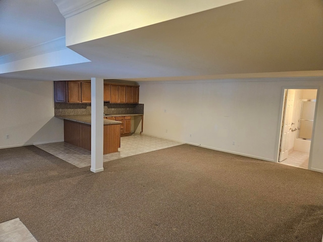 finished basement with baseboards and light colored carpet