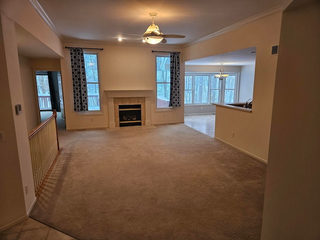 unfurnished living room featuring light carpet, baseboards, visible vents, a tile fireplace, and crown molding